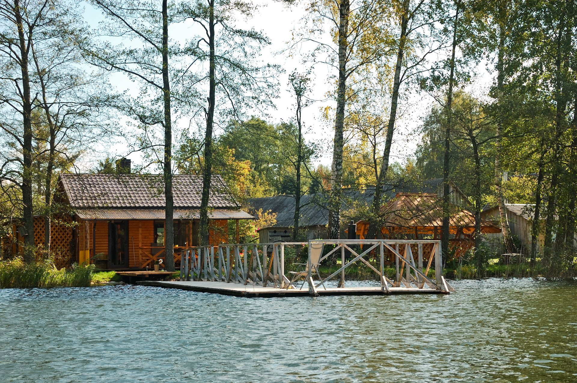 Small cozy wooden sauna by the lake and pier to take a swimm.